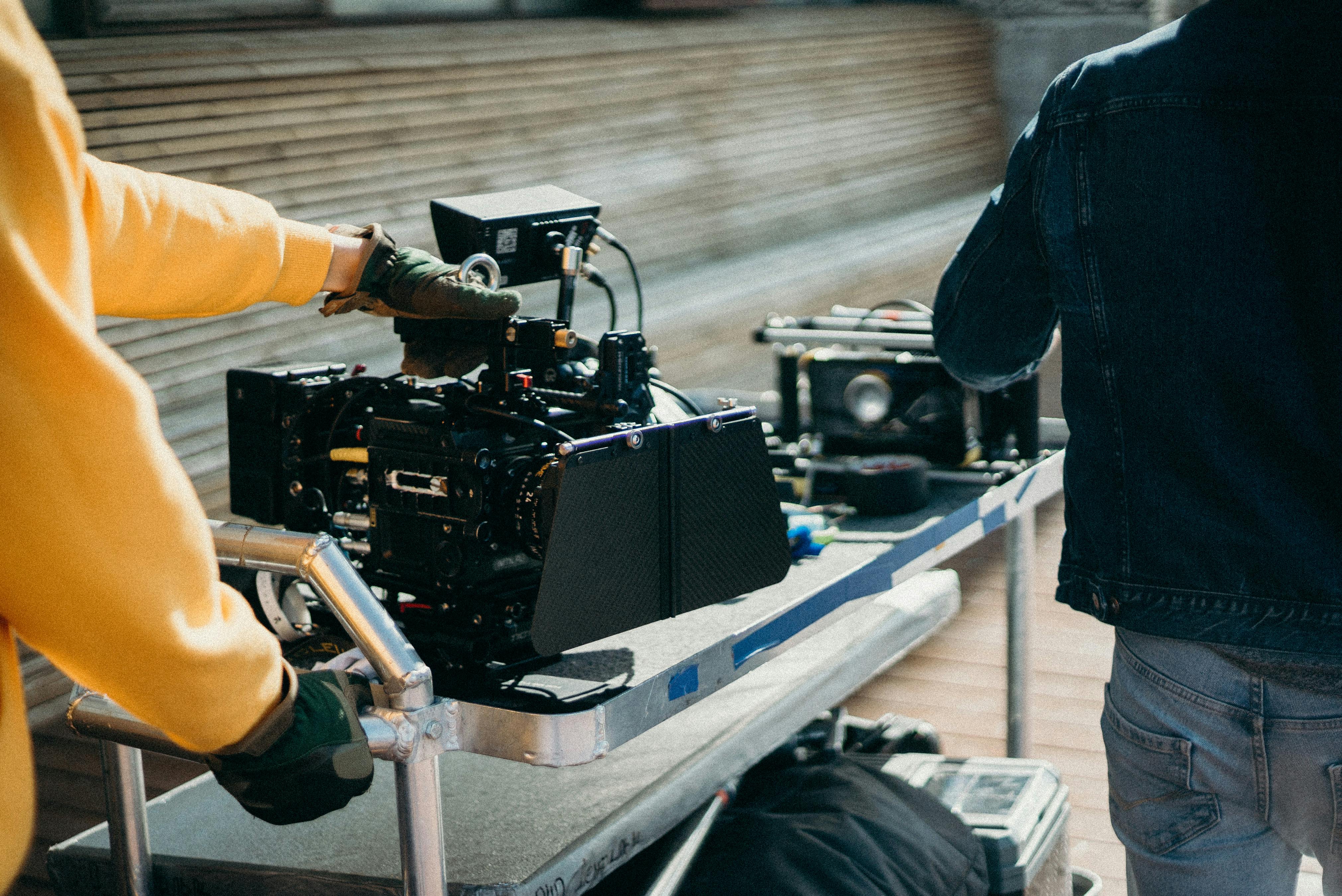 a director on set, camera focused on two actors mid-dialogue, capturing the essence of the scene from a distance that reveals both their expressions and the context of their environment.