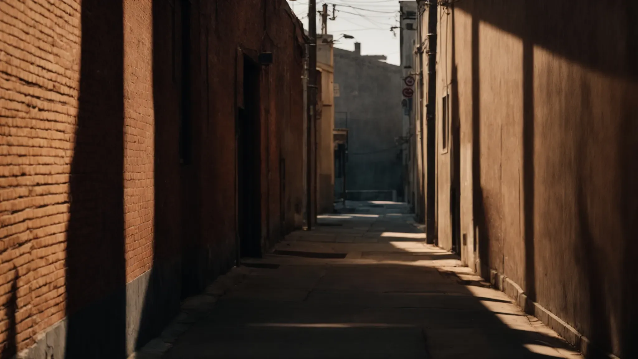 muted streetlights cast long shadows over an empty alleyway, evoking the latent tension of a gangster's domain.