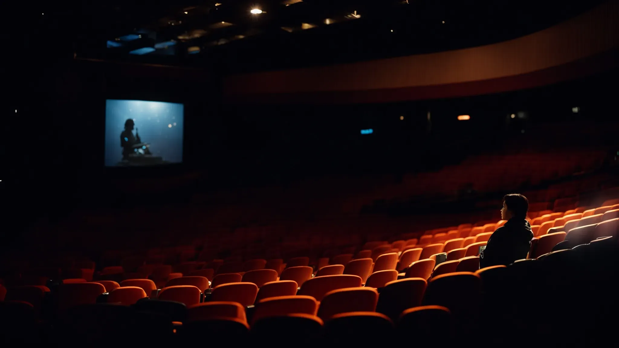 a silhouette of a person sitting in a movie theater, eyes fixed on a glowing screen showcasing a vivid science fiction scene.