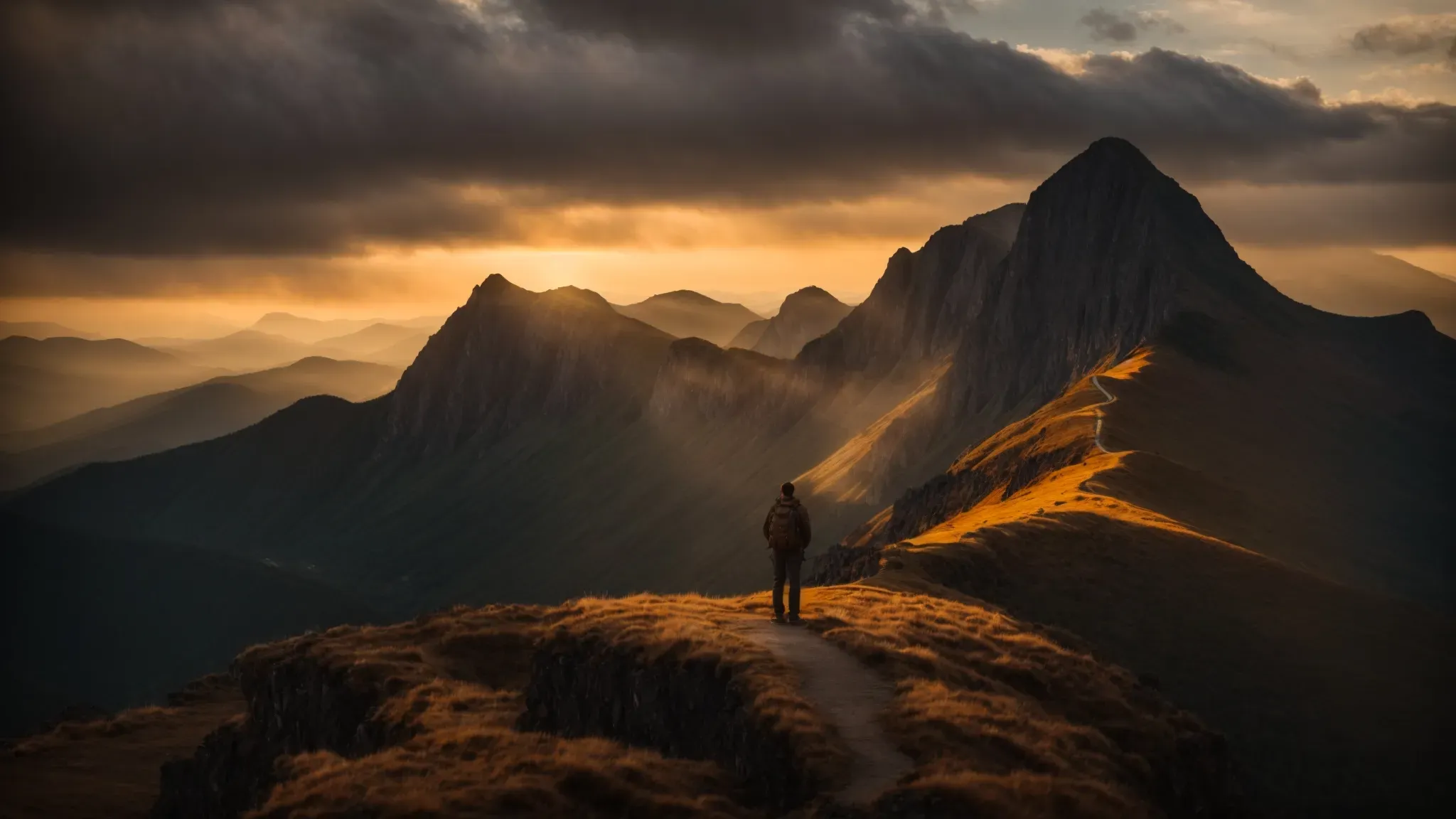a sun setting behind majestic mountains, casting a golden glow that complements a solitary figure standing at the edge of a cliff, overlooking a vast, untouched wilderness.