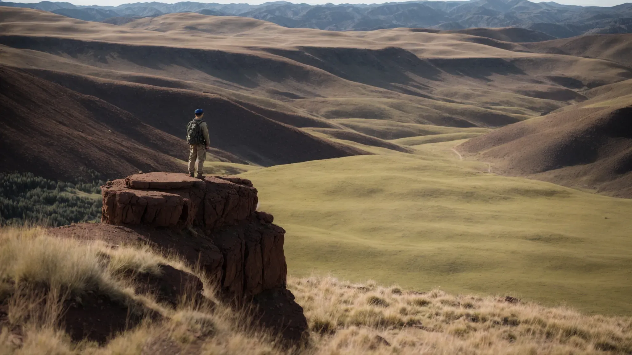 a scout surveys the vast expanse of an empty, sunlit valley, potential for a movie set.