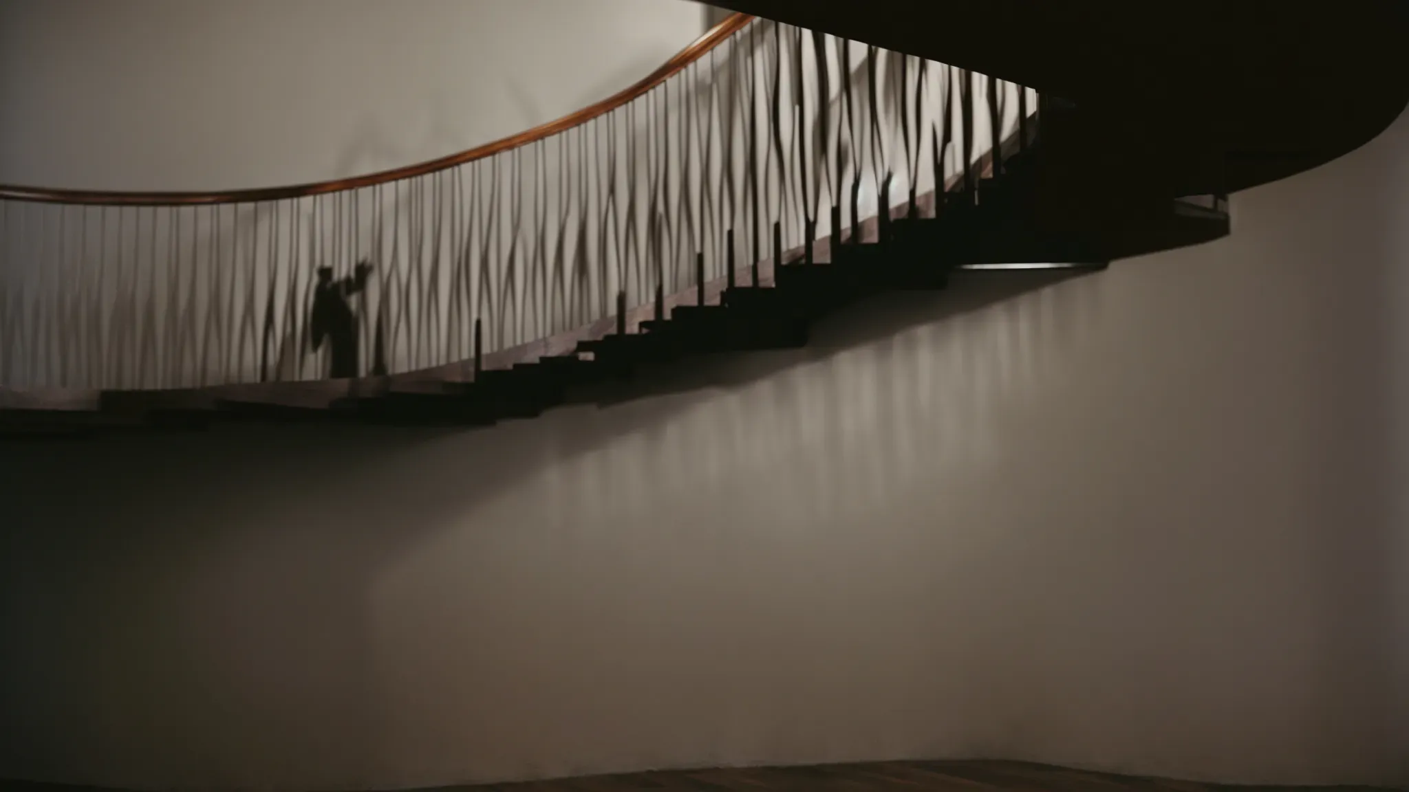 a spiral staircase casts a dizzying shadow against the wall as a silhouetted figure ascends, embodying the chilling essence of hitchcock's suspenseful misdirection.