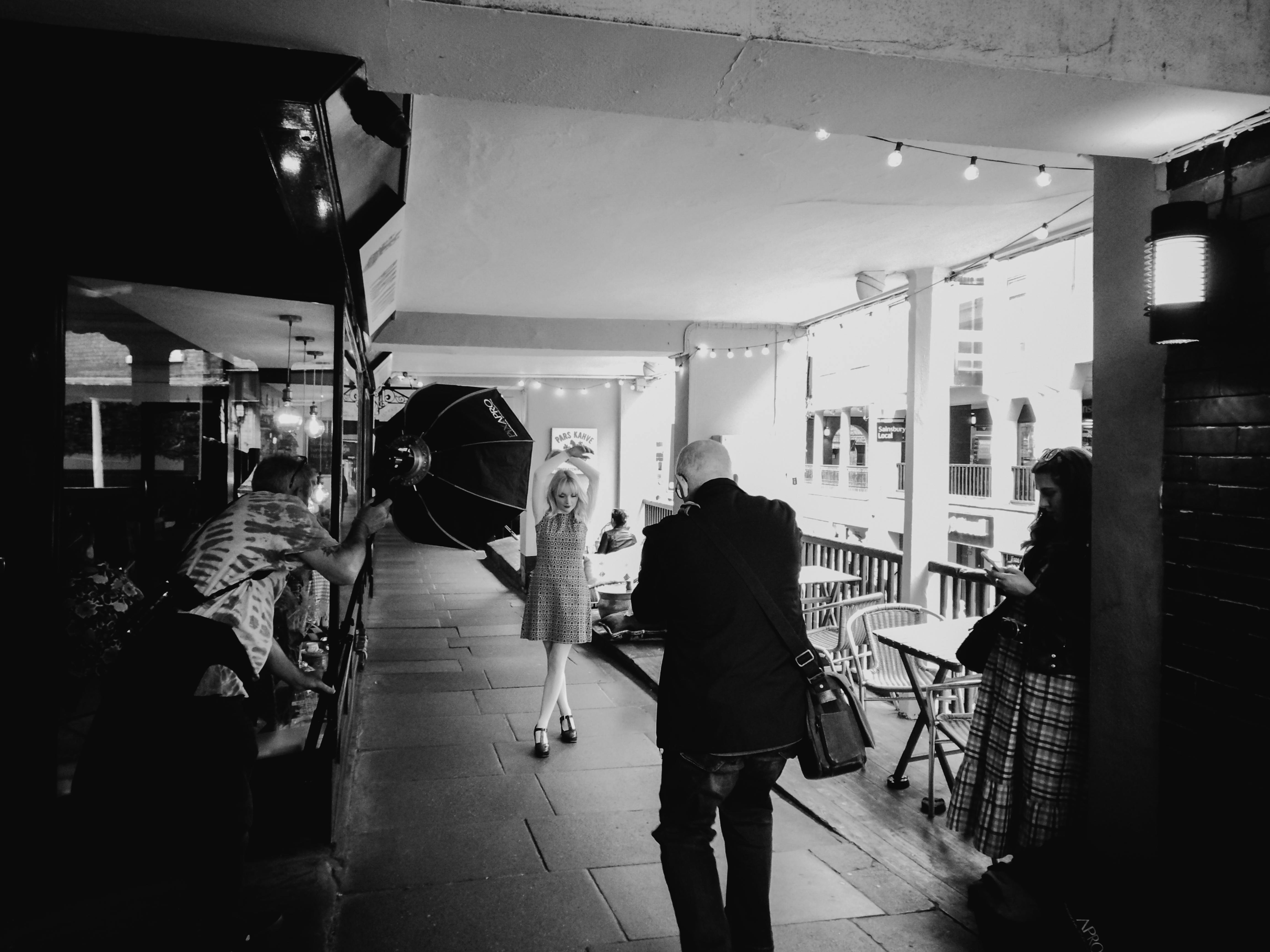 a photographer and a client are reviewing a portfolio of images displayed on a large screen in a modern, well-lit studio.