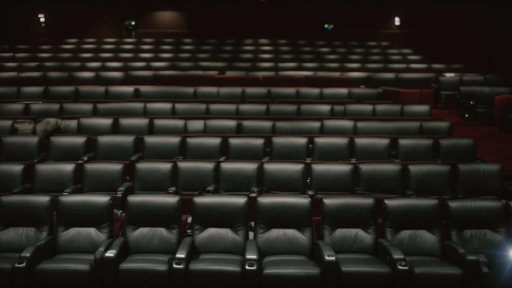 a serene movie theater with empty seats and a blank screen poised for the rolling of closing credits.