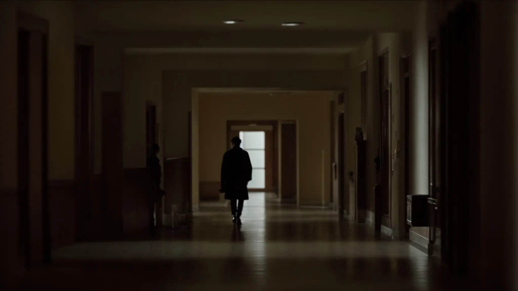 a solitary figure wanders the ominous, deserted hallways of the overlook hotel.