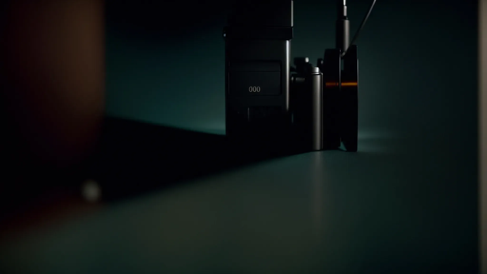 a reel of film unwinding across a dimly lit room, casting shadows that morph into iconic scenes from groundbreaking movies of the 2000s.