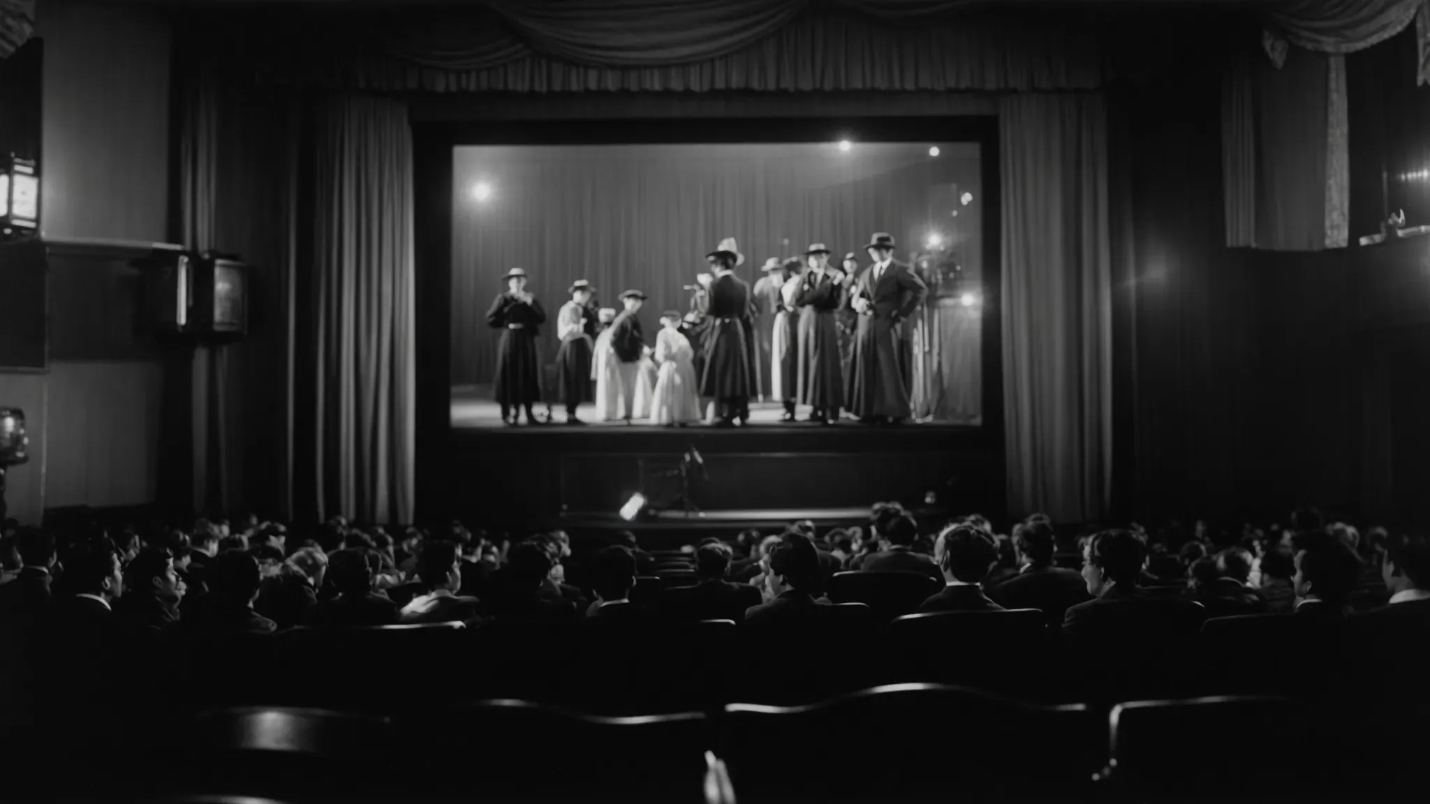 a black and white image of an early 1900s silent film being projected in a vintage cinema.