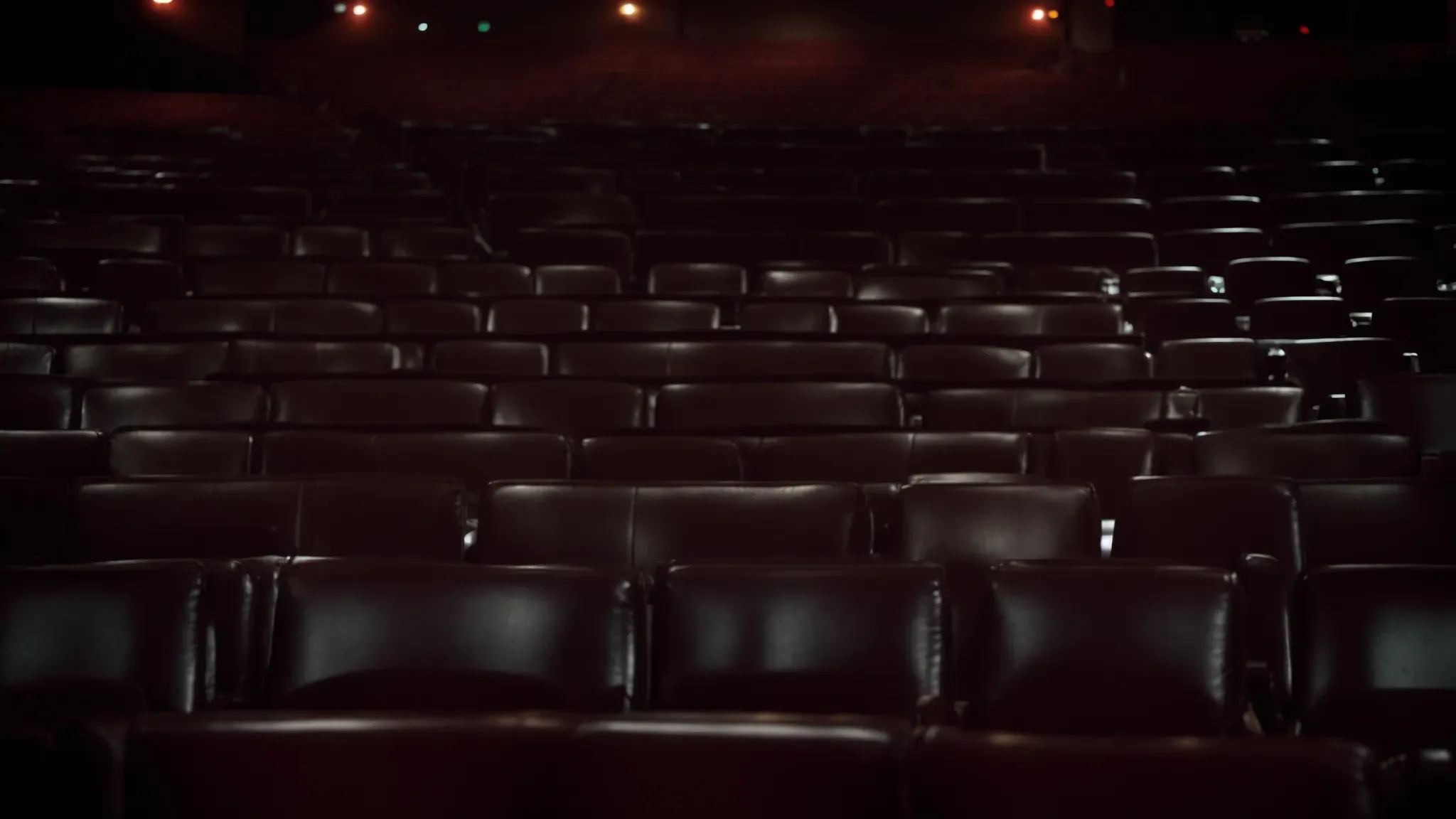 a dimly lit cinema hall, with rows of empty seats facing a large screen showcasing a classic film montage.