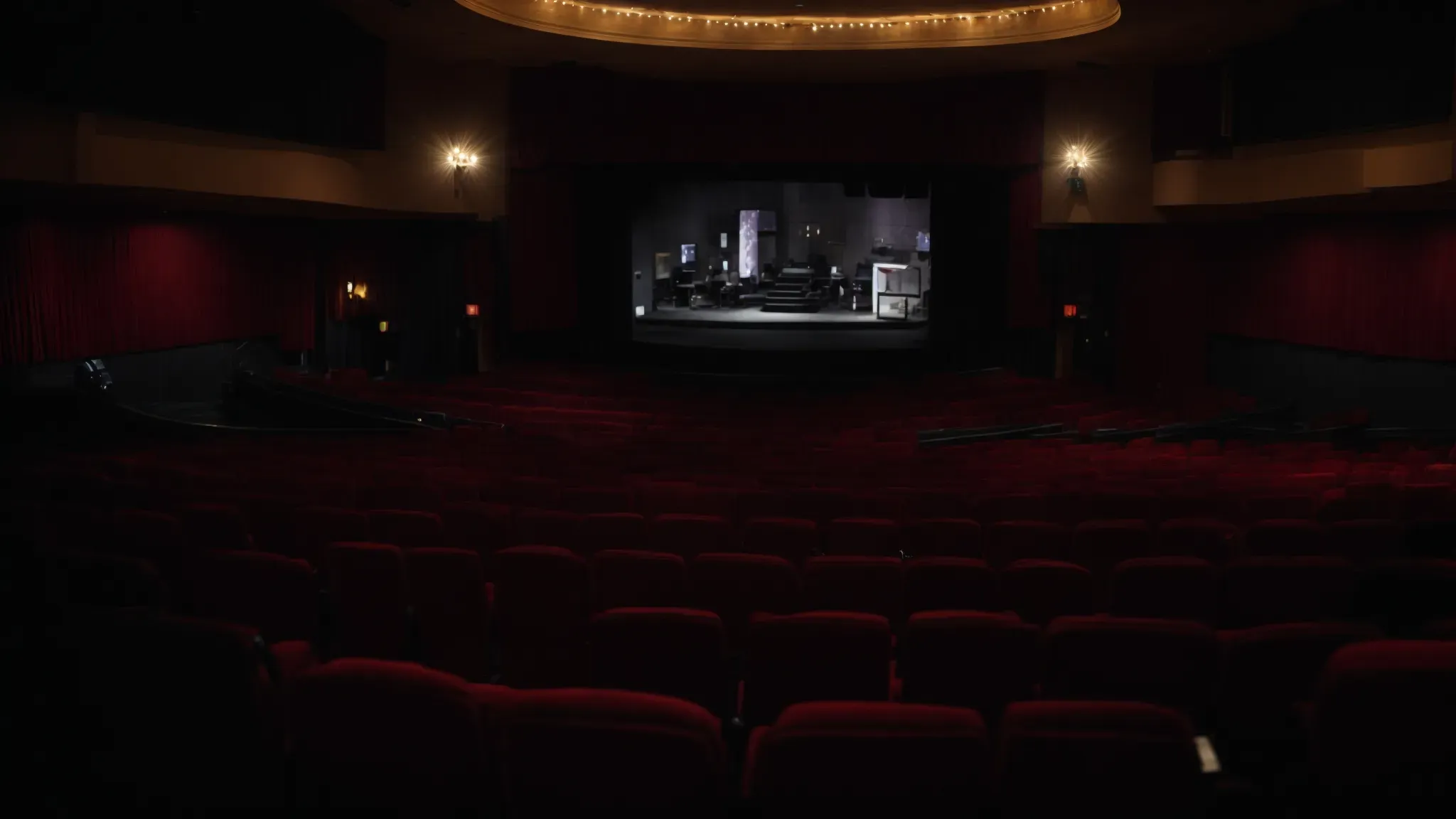 a wide view of theater seats facing an illuminated screen, showcasing the cinematic journey of biopics without any visible audience.