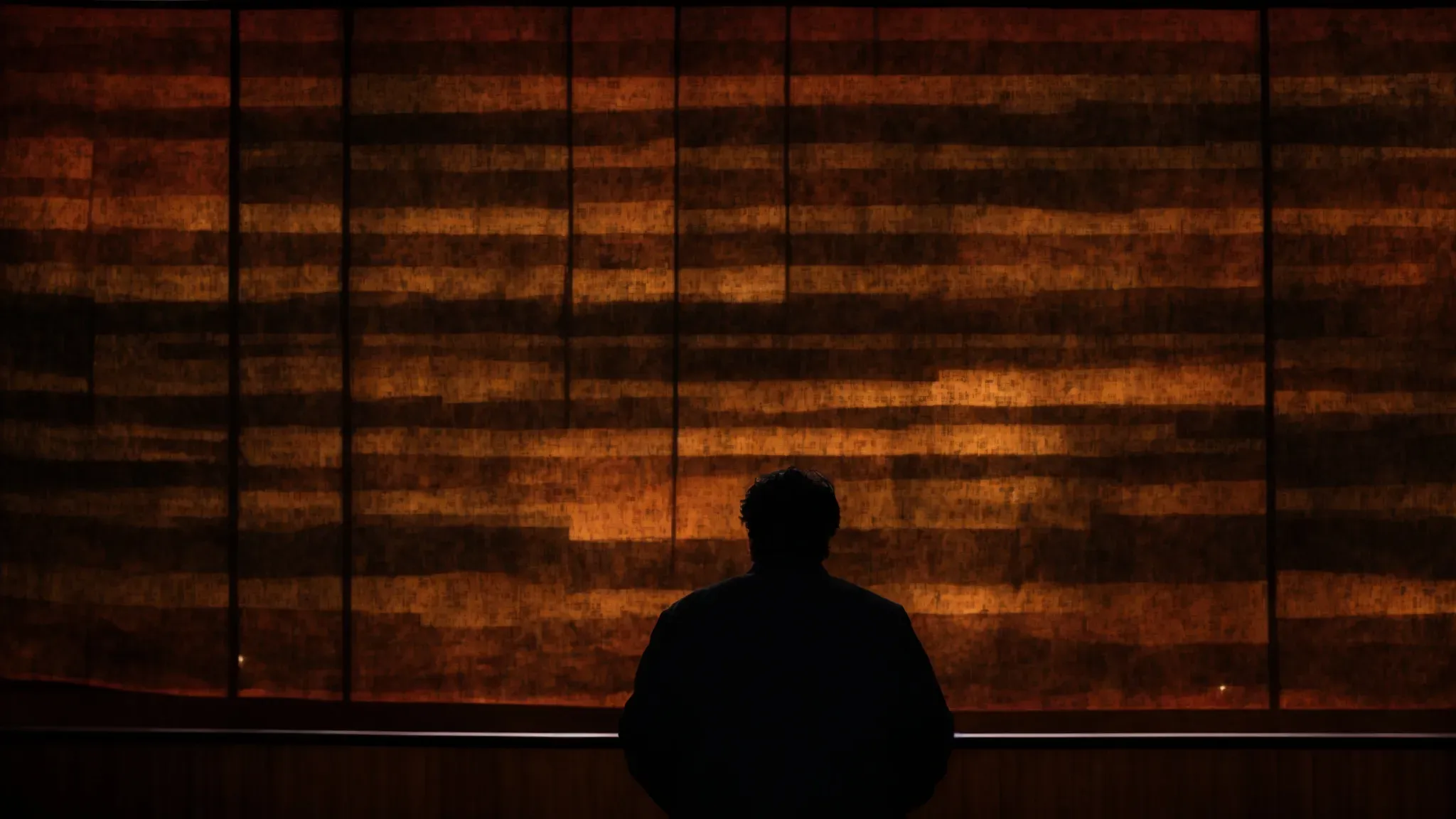 a silhouette of guillermo del toro stands against an evolving tapestry of his iconic film scenes, showcasing a timeline from 'cronos' to 'nightmare alley'.