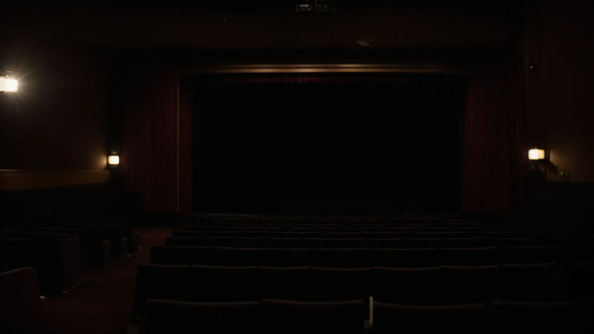 a dimly lit theater with an empty screen ready to display the end credits.