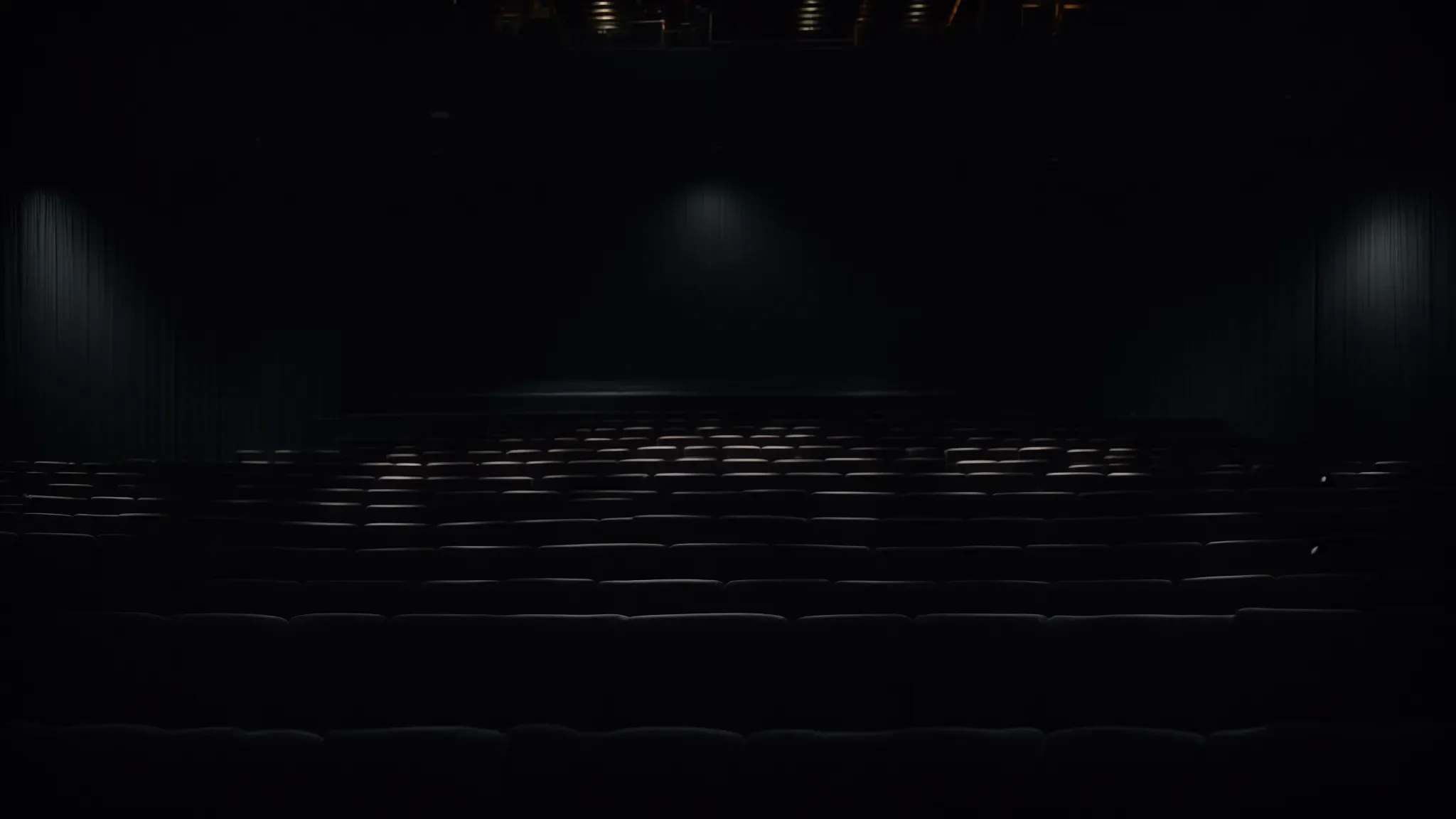 a vast, empty cinema auditorium waits in semi-darkness, with the screen glowing softly, poised to unveil the next eerie tale of transformation.