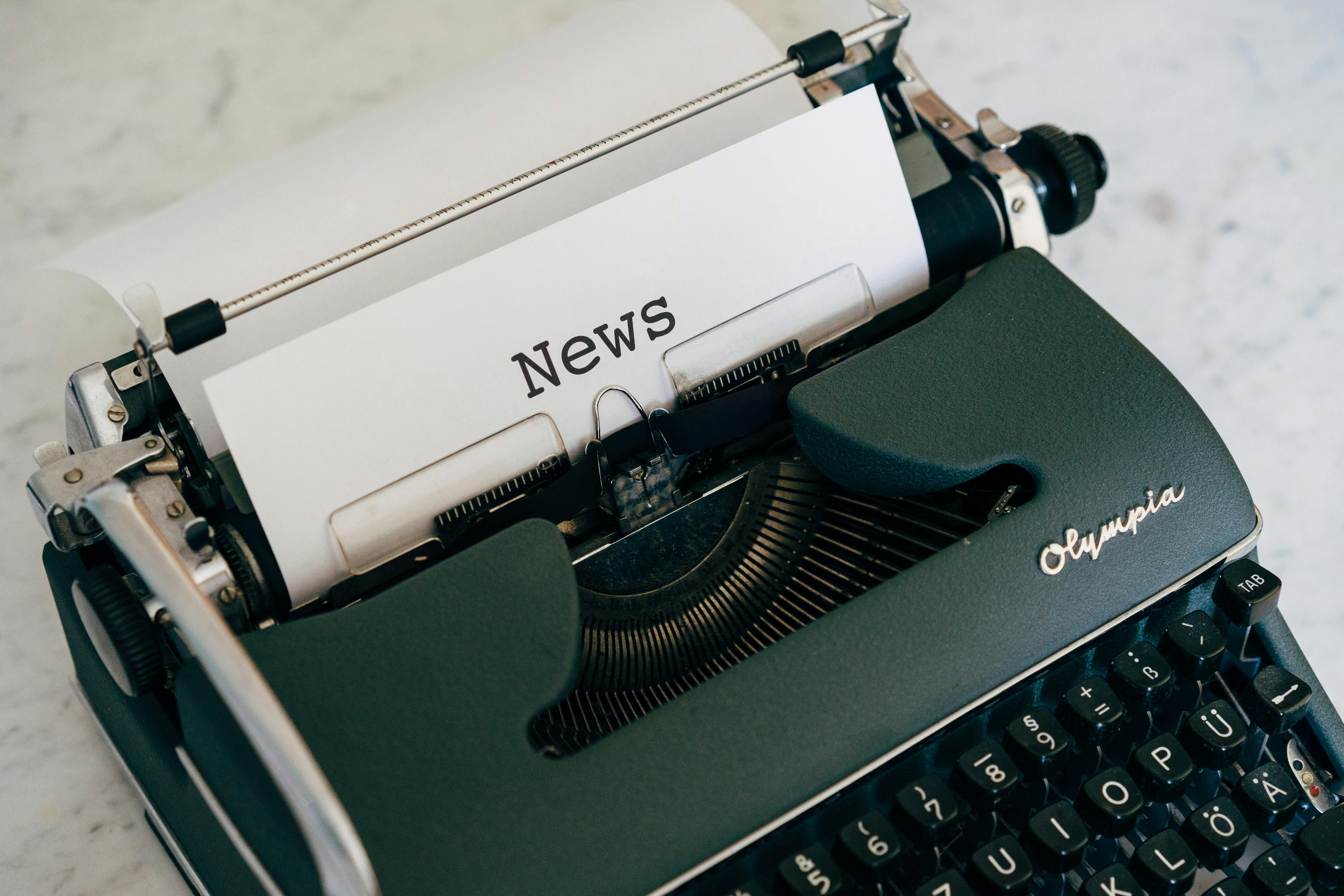 a vintage typewriter on an old wooden desk, surrounded by scattered screenplay pages under a dim light.